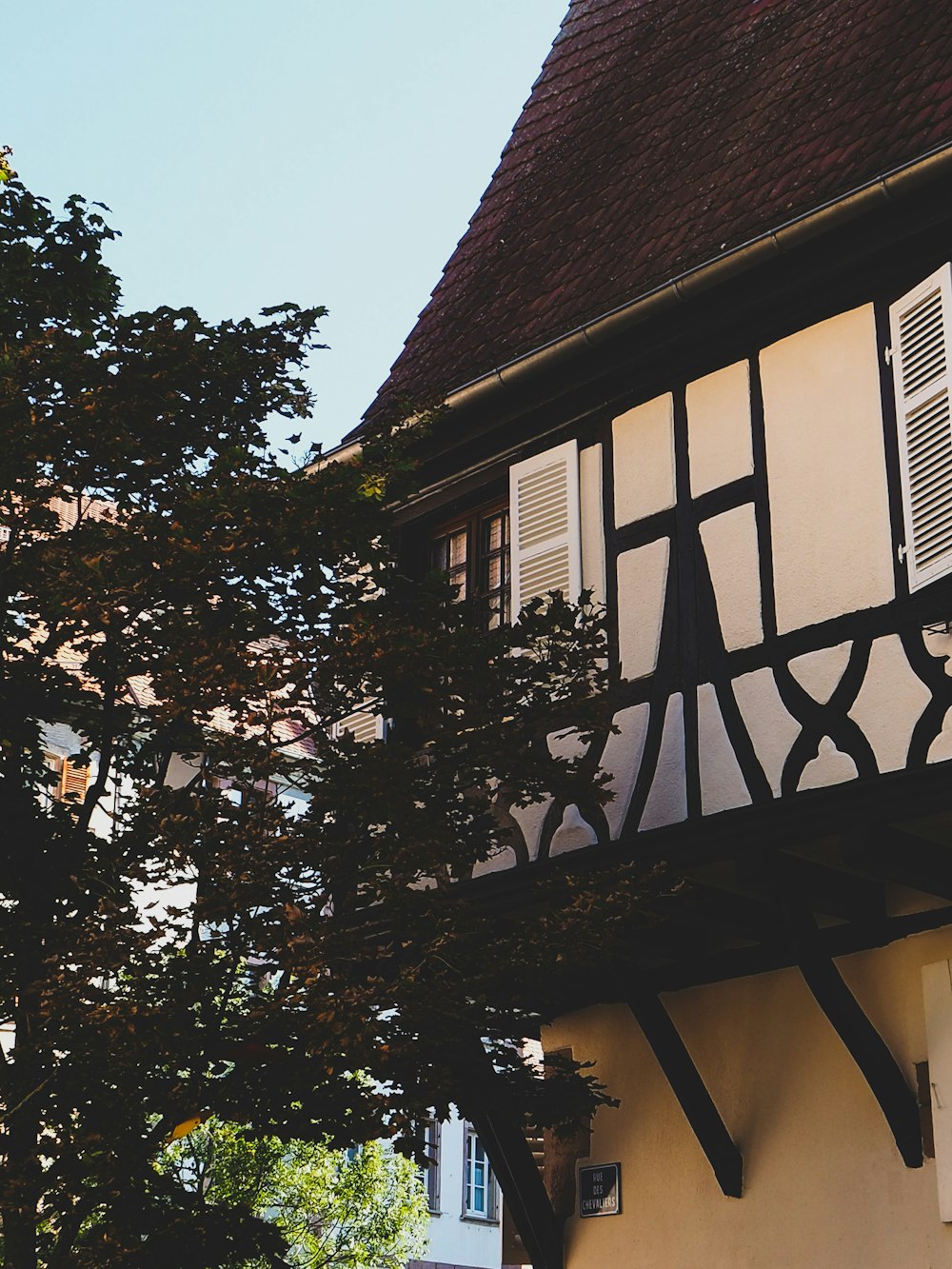 a black and white building with a clock on it's side