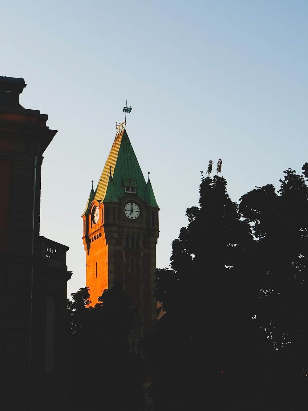 a tall clock tower with a clock on each of it's sides