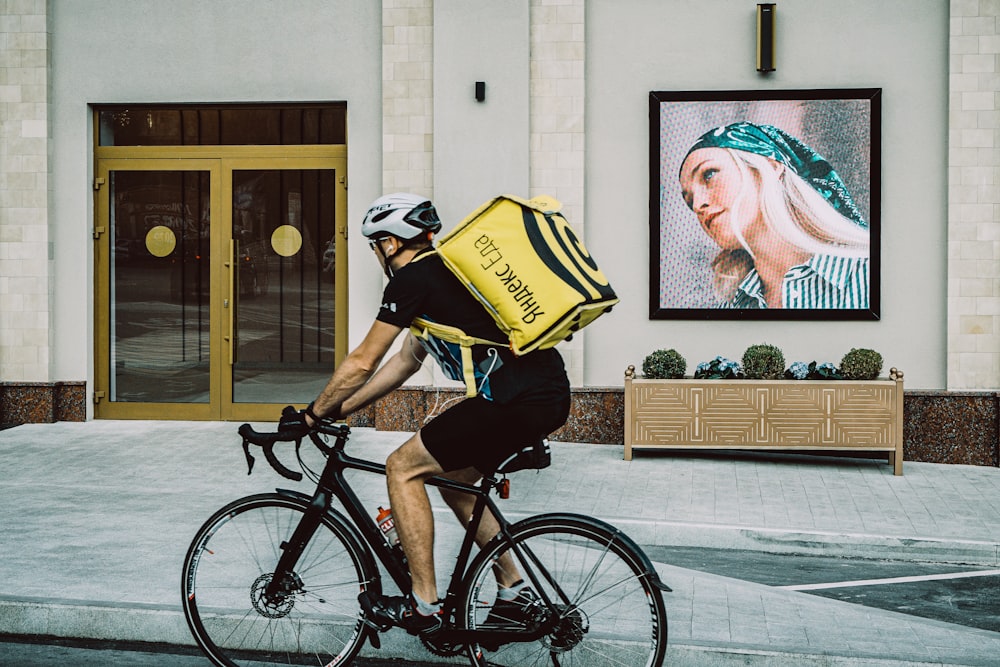 a man riding a bike down a street