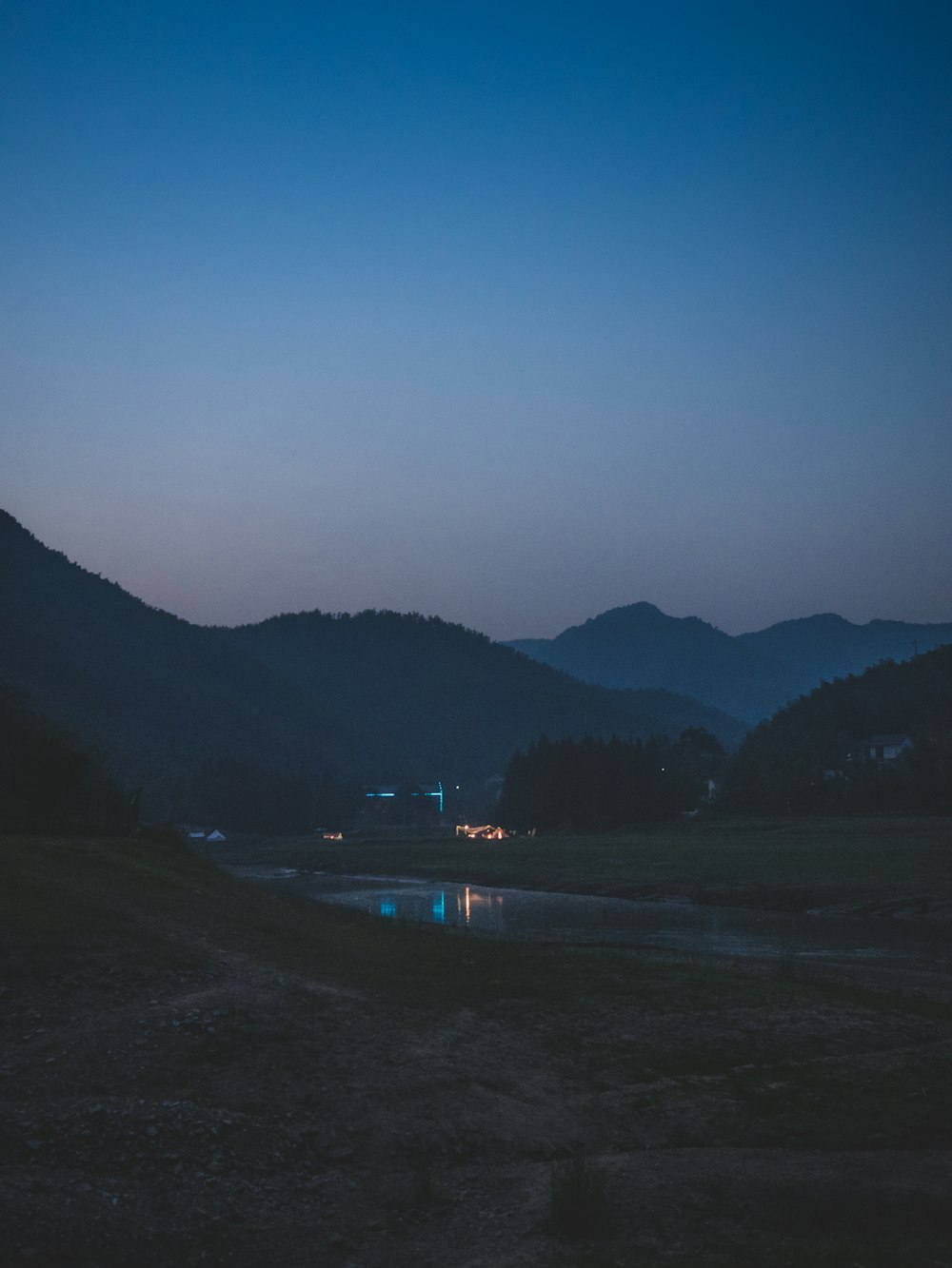 a body of water with mountains in the background