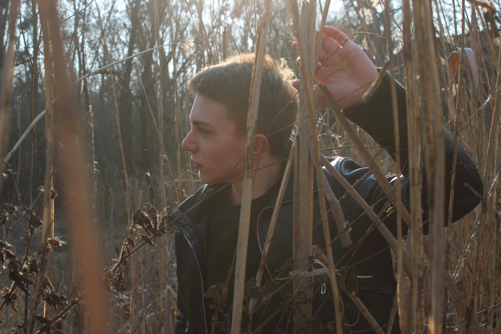 a man standing in a field of tall grass