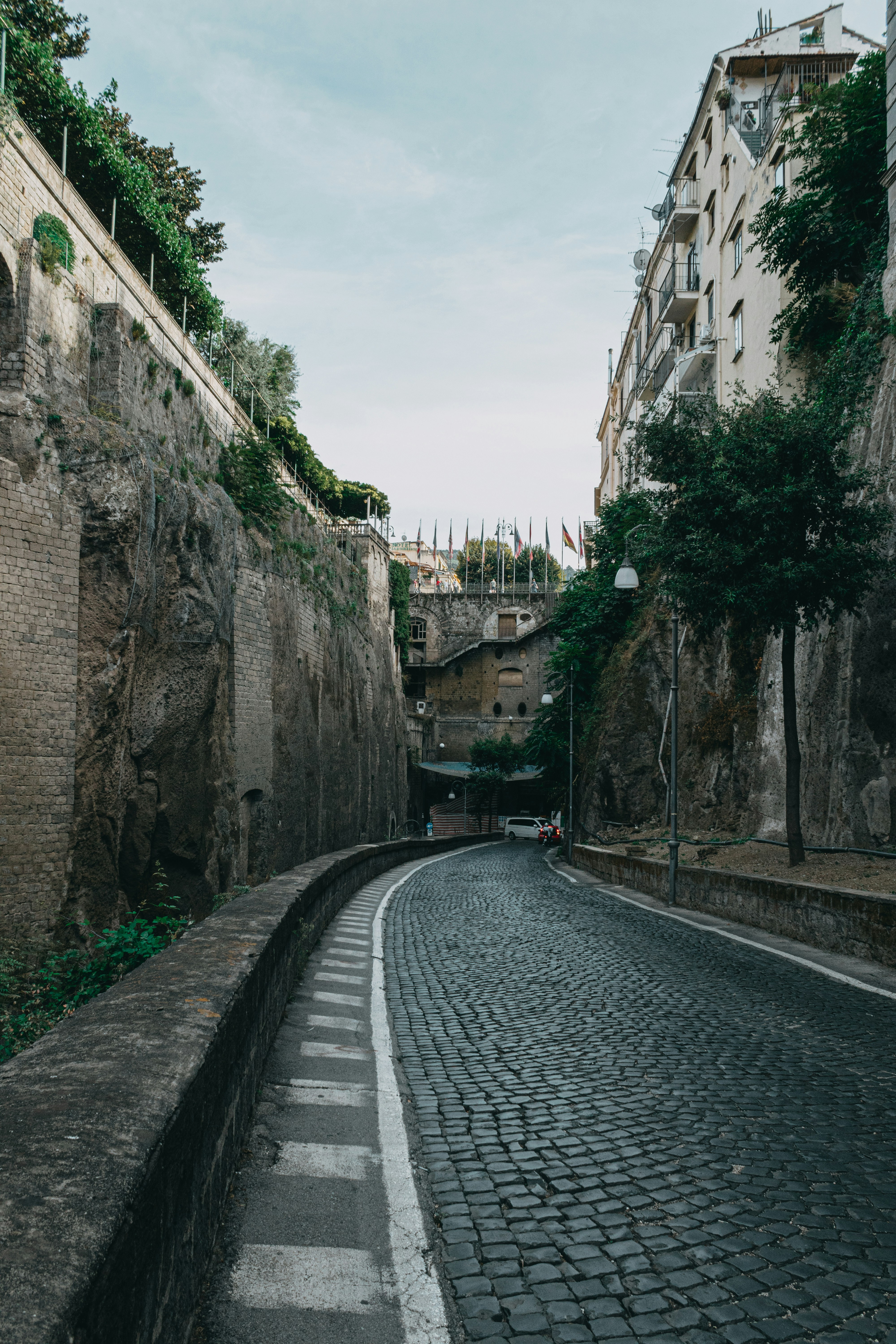 a cobblestone street in a city with buildings on either side