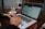 A close-up of a person typing on a laptop with a coffee cup nearby.