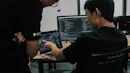 two men working on computers in an office