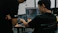 two men working on computers in an office