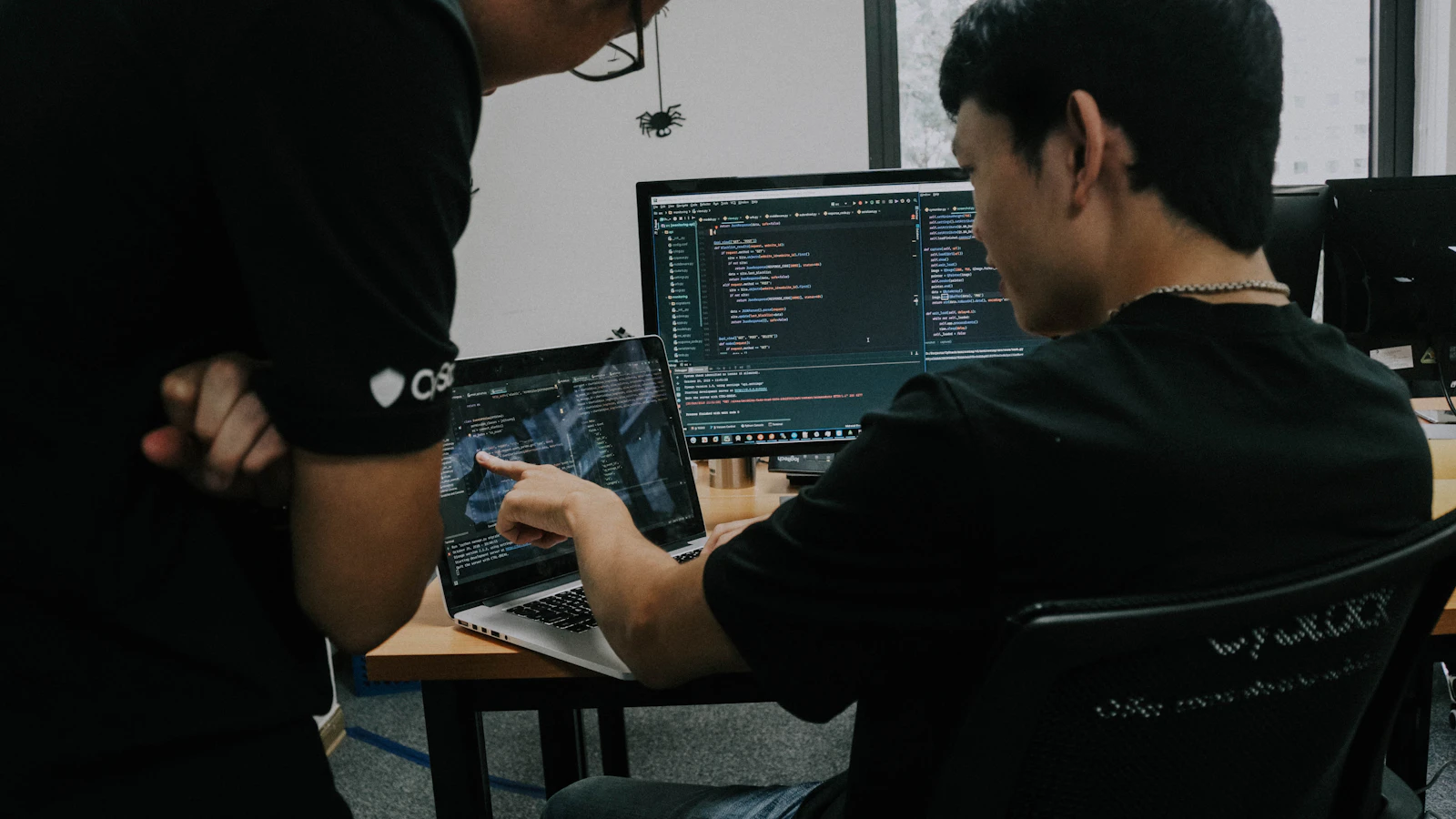 Two young developers collaborating at a laptop