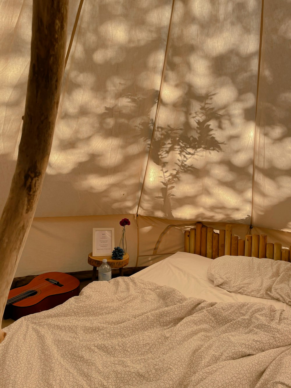 a bed with a white comforter under a canopy