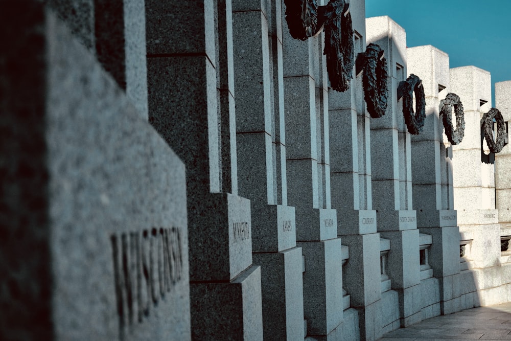 a row of concrete blocks with a clock on each of them