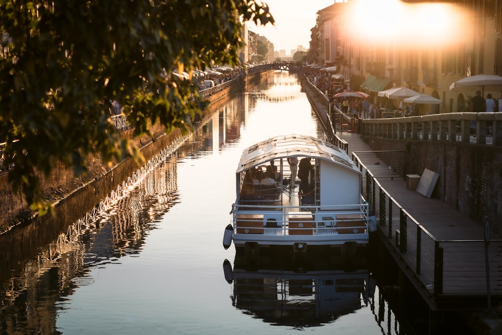 a boat is docked in the water next to a bridge