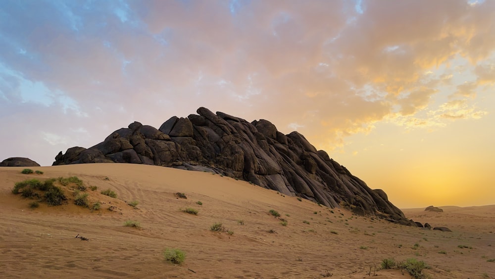 a large rock formation in the middle of a desert