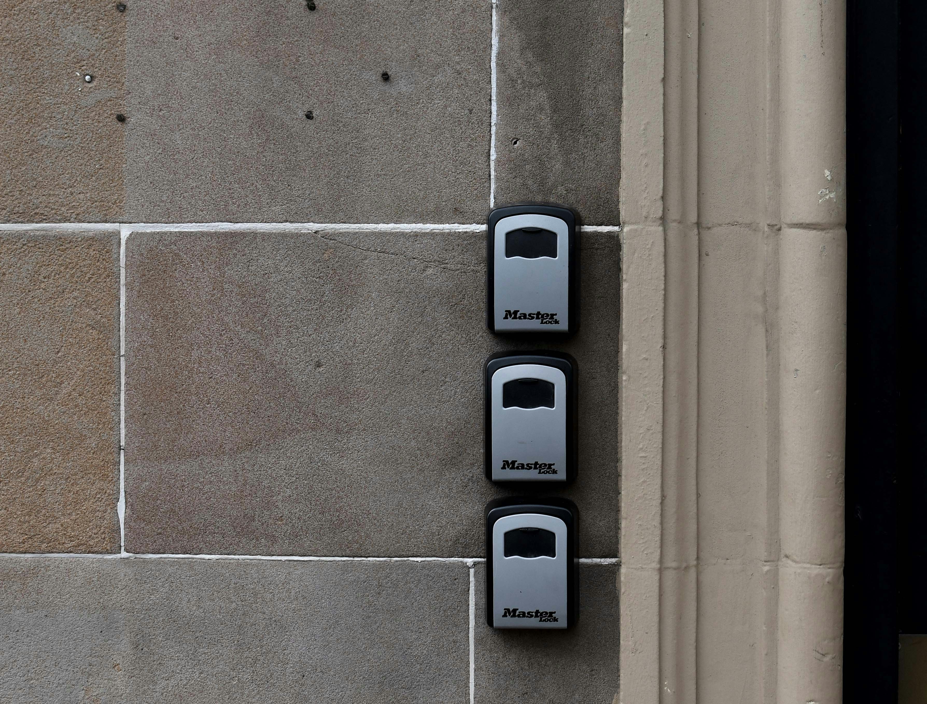 a couple of black and white phones on a wall