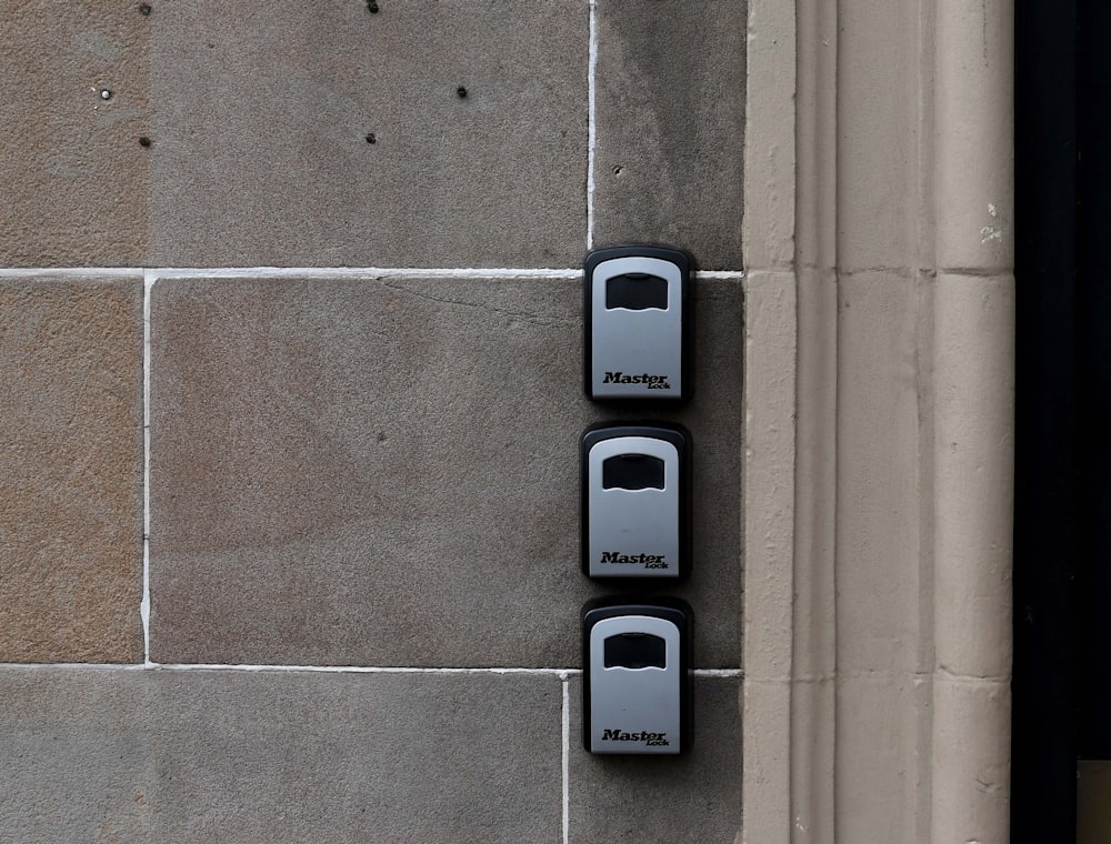 a couple of black and white phones on a wall