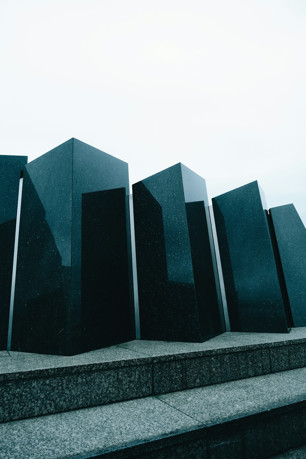 a row of black blocks sitting on top of a cement step
