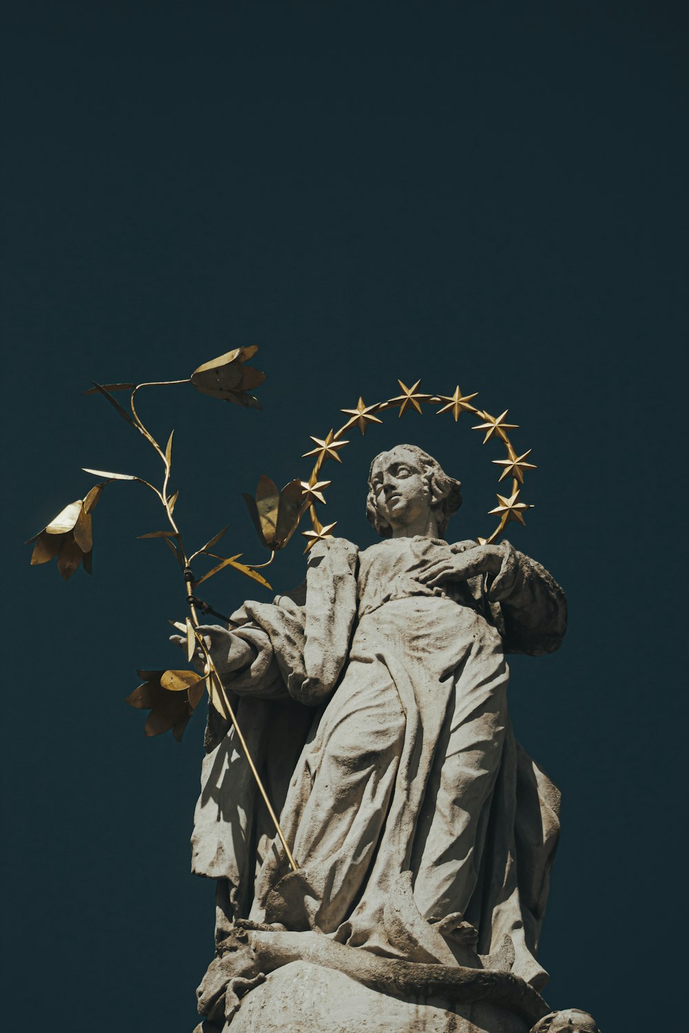 a statue of a person holding a star