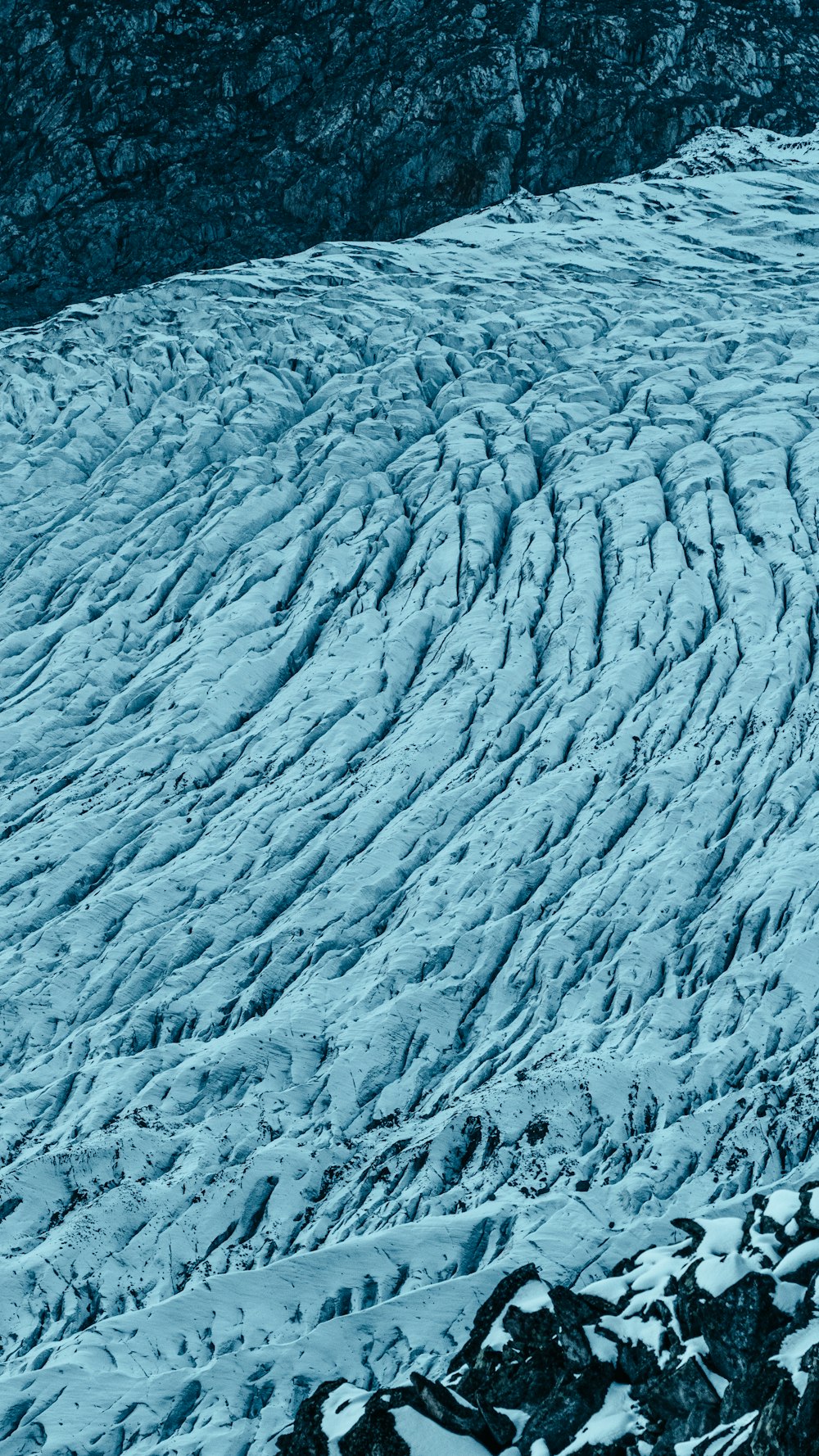 a man riding skis down a snow covered slope