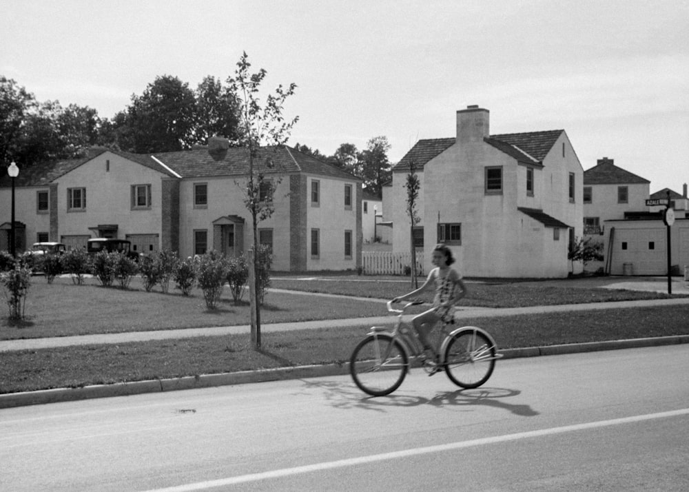a woman riding a bike down a street