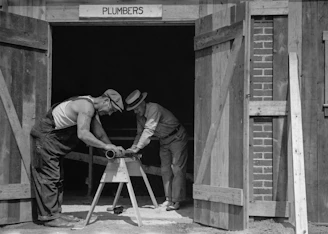a couple of men working on a wooden structure