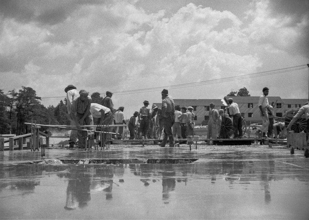 a group of people standing around a pool of water