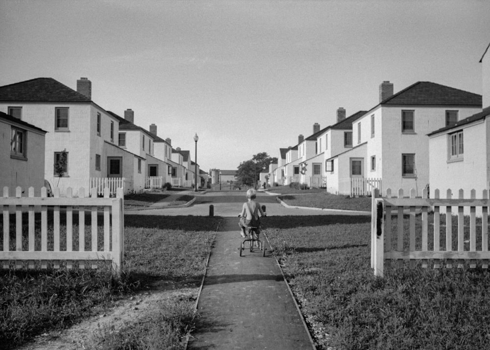 a person riding a bike down a sidewalk