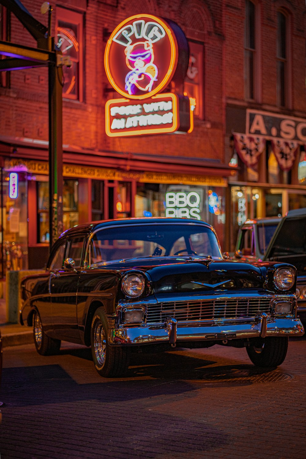 a car parked on the side of the road in front of a building