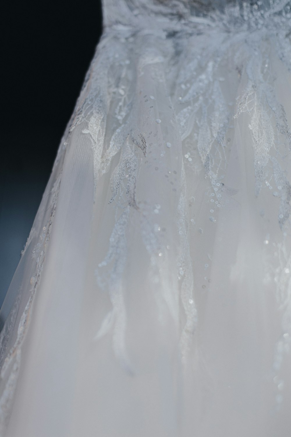 a close up of a wedding dress with water droplets on it