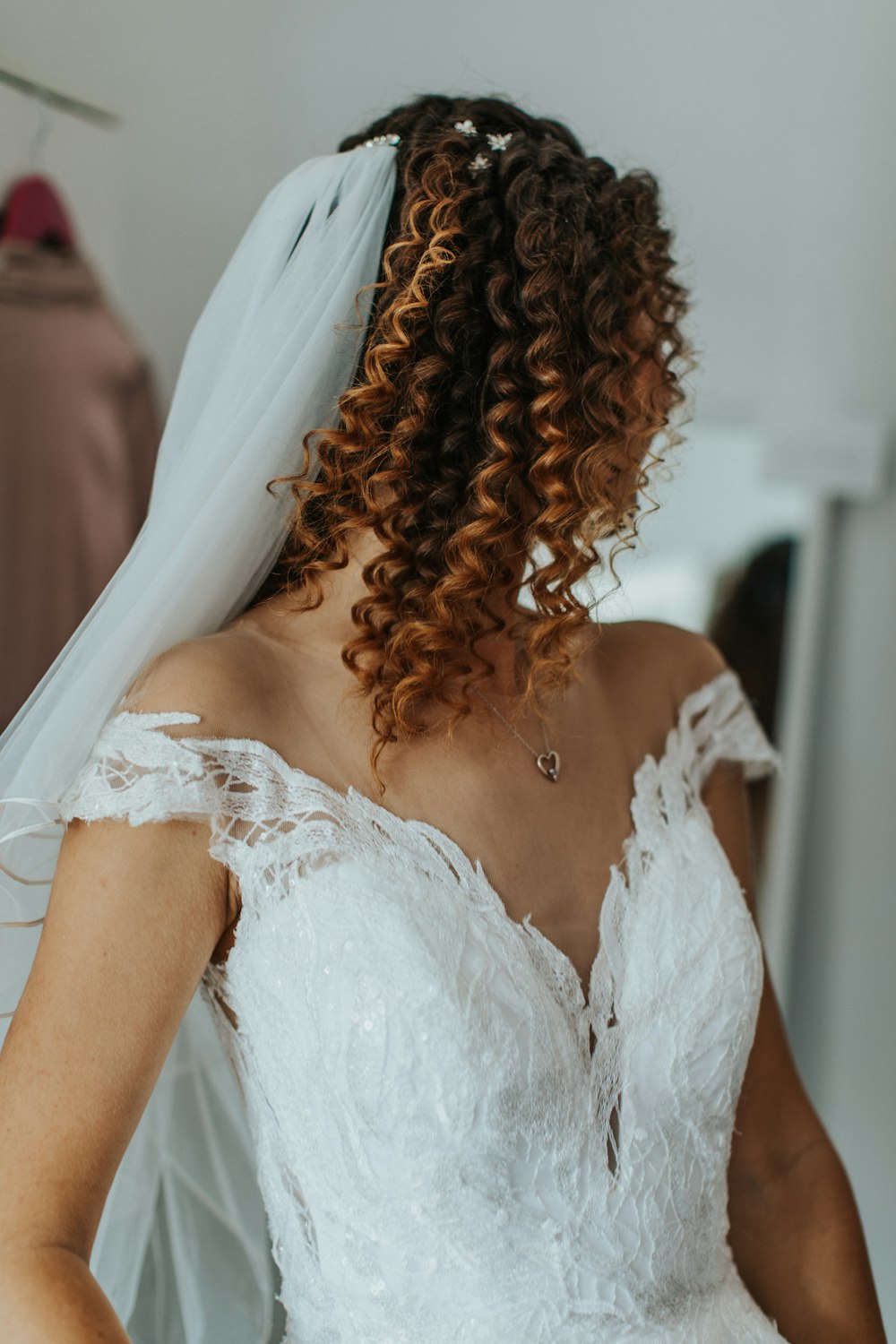 a woman in a wedding dress with a veil on her head