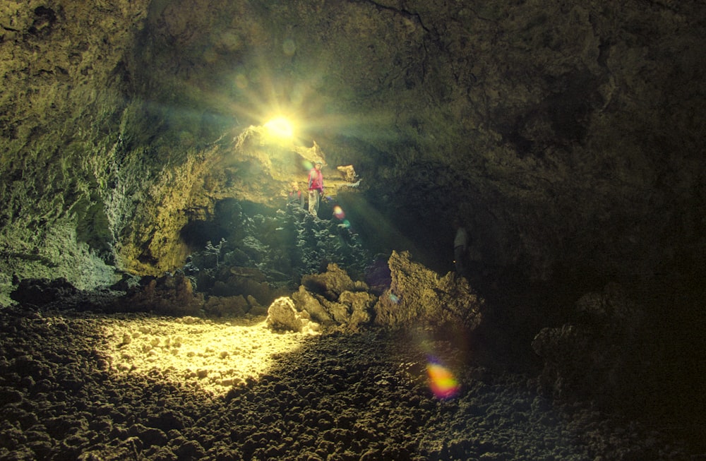 a group of people standing inside of a cave