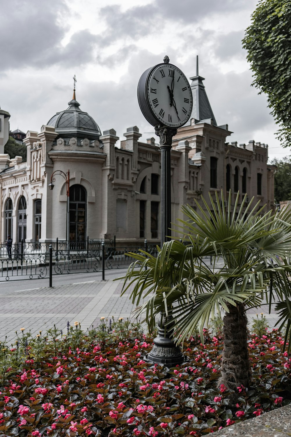 a clock on a pole in front of a building