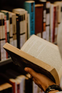 a person reading a book in a library