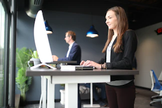 a woman sitting at a desk in front of a computer