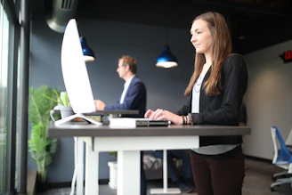 a woman sitting at a desk in front of a computer