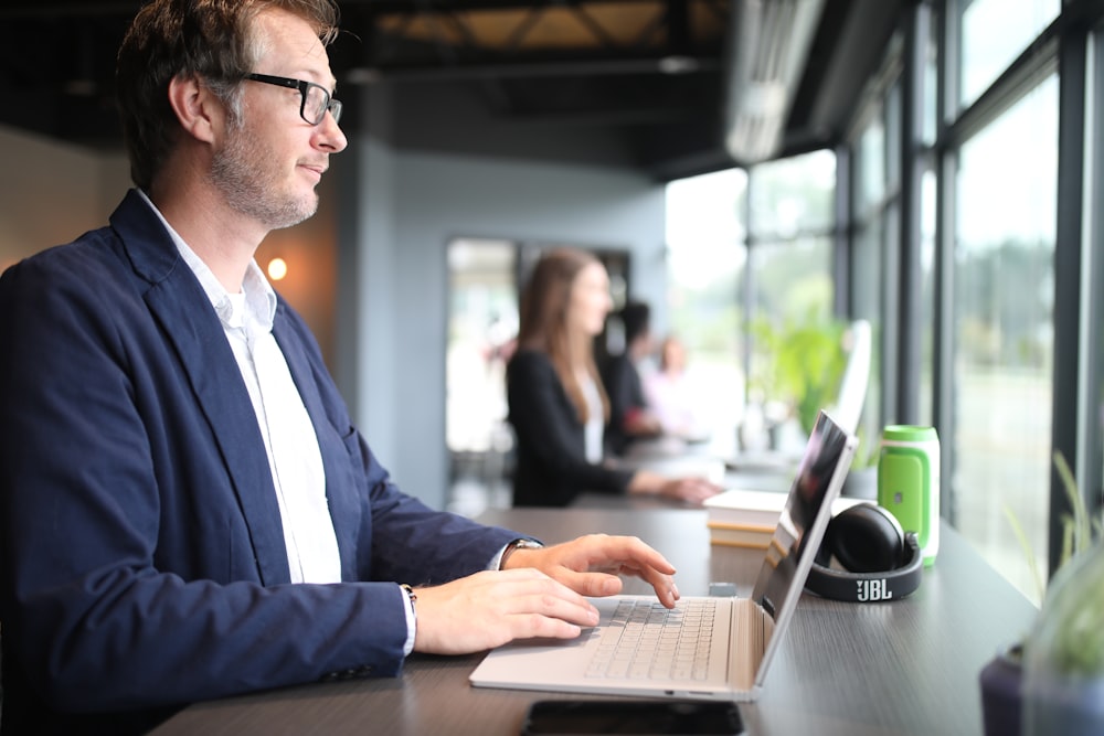 a man sitting in front of a laptop computer