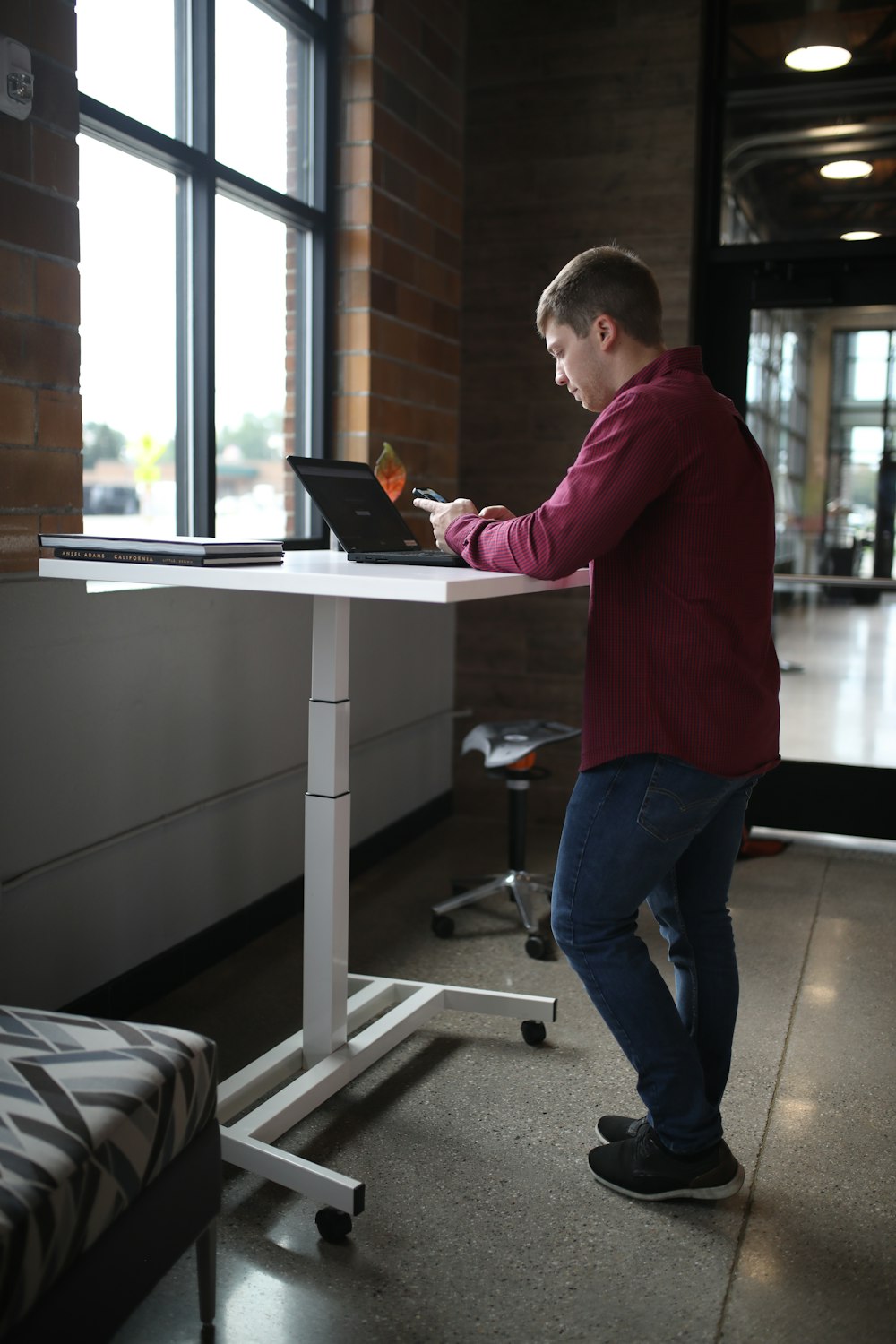 a man standing in front of a laptop computer