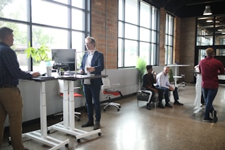 a group of people standing around a desk