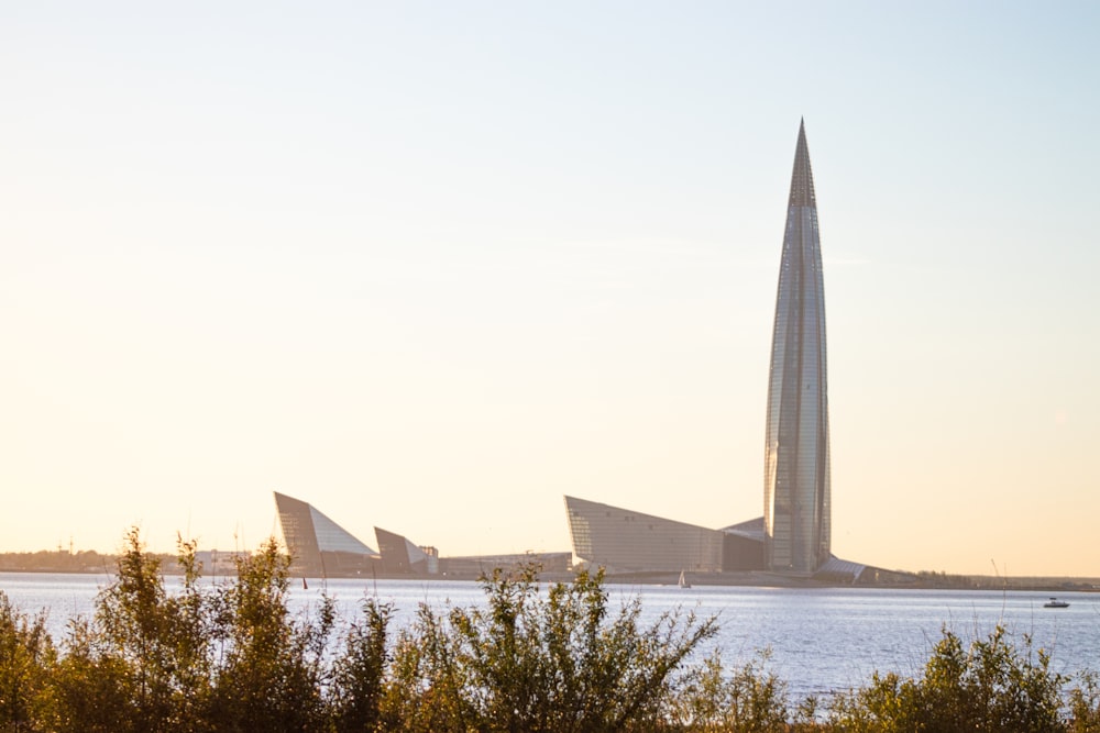 a tall building sitting next to a body of water