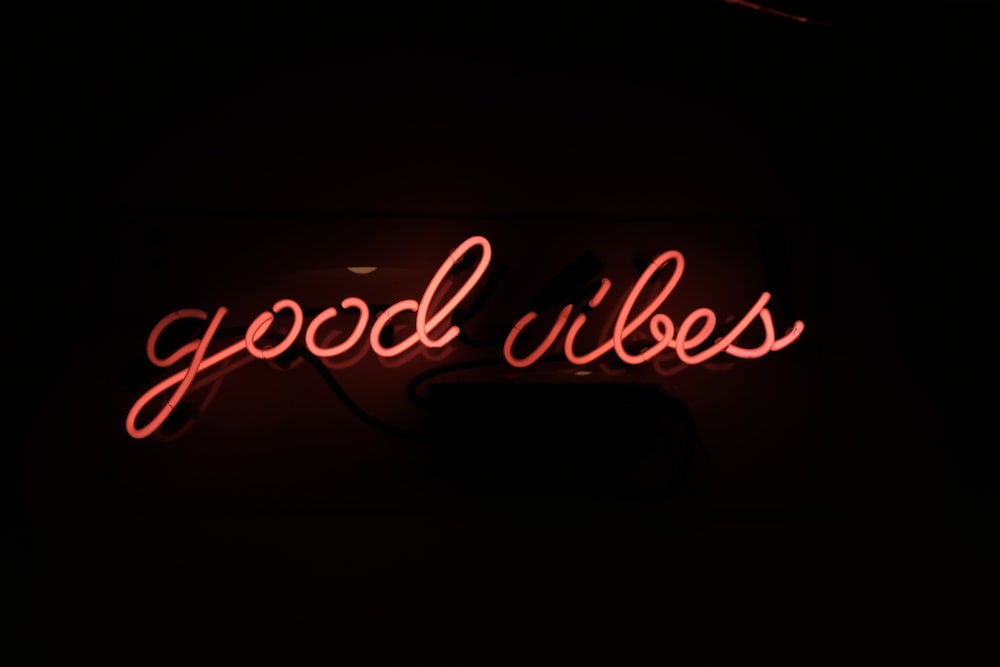 a neon sign that reads good vibes