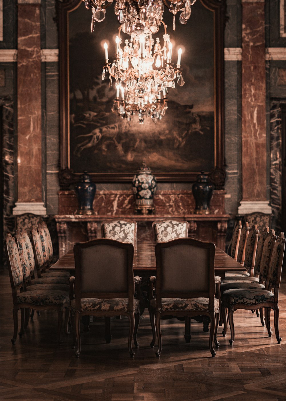 a dining room with a chandelier hanging from the ceiling