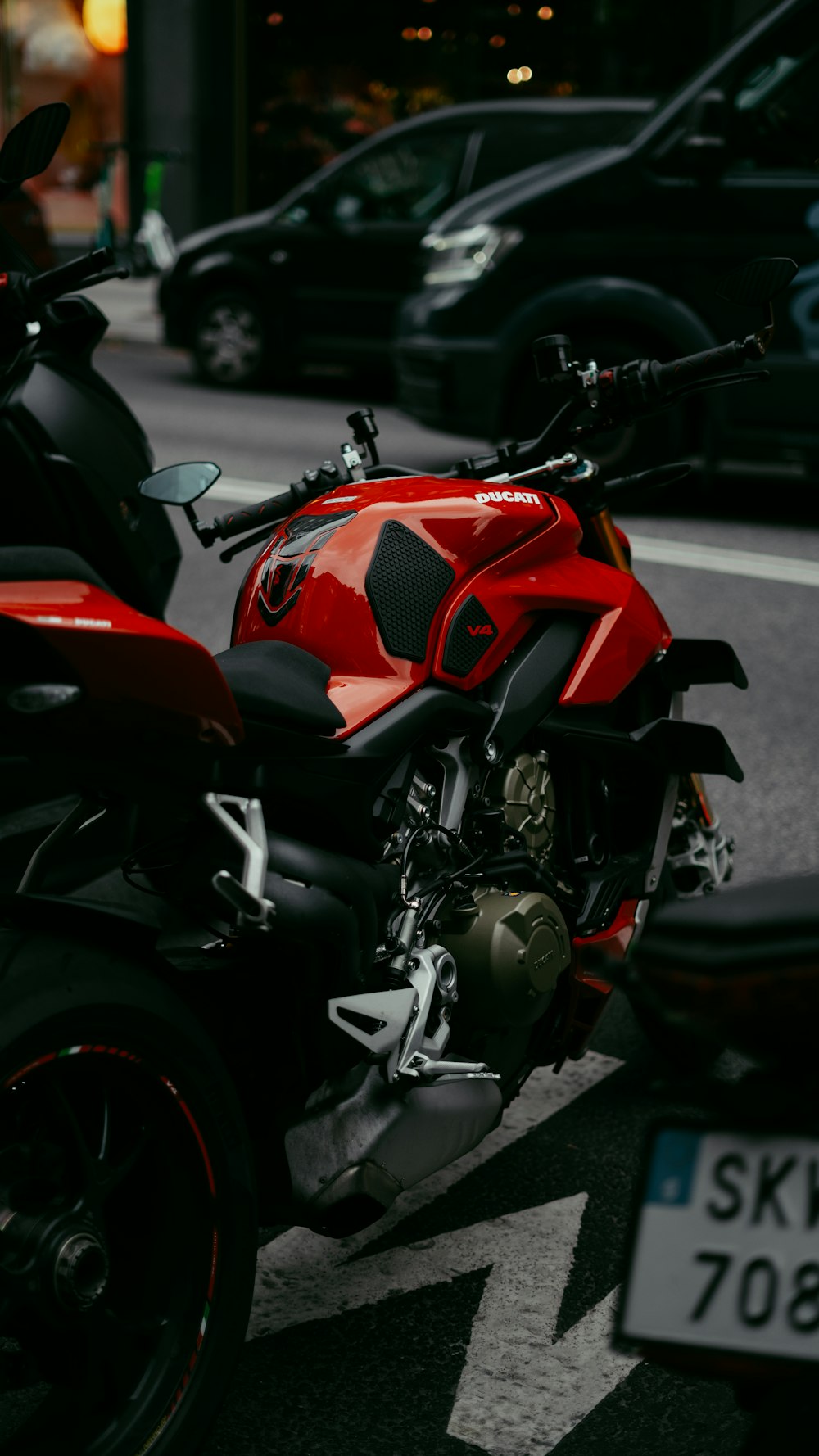 a red motorcycle parked on the side of the road