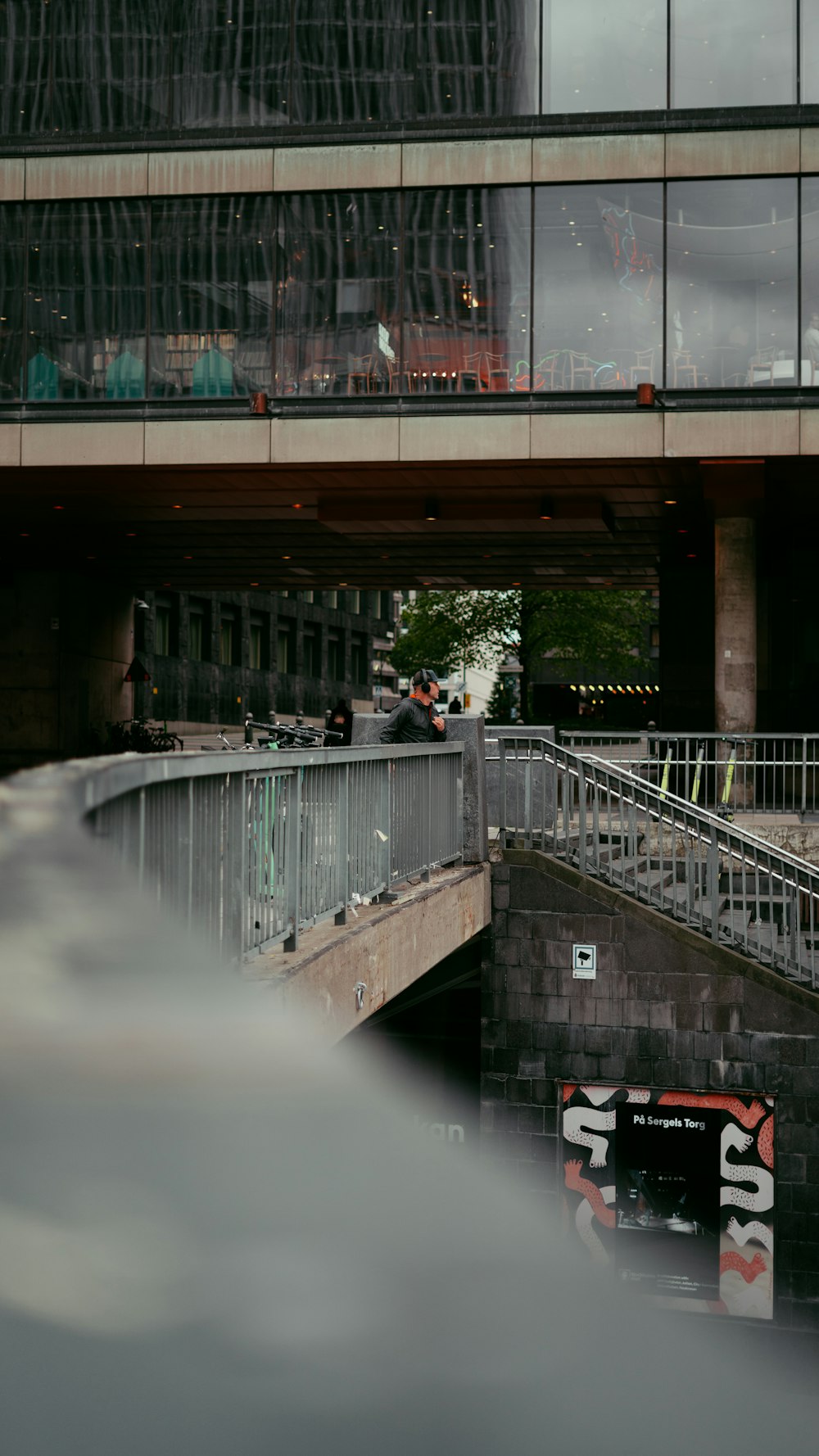 a bridge over a body of water next to a tall building