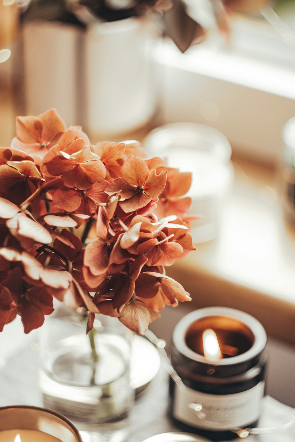 a candle and some flowers on a table