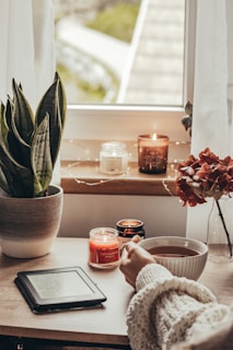 a person sitting at a table in front of a window