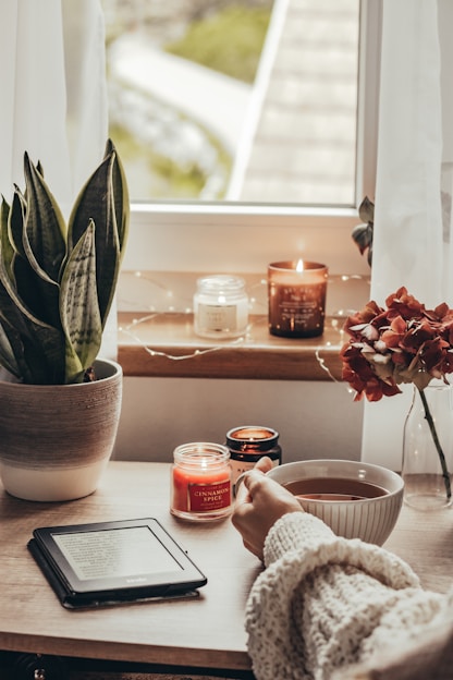 a person sitting at a table in front of a window