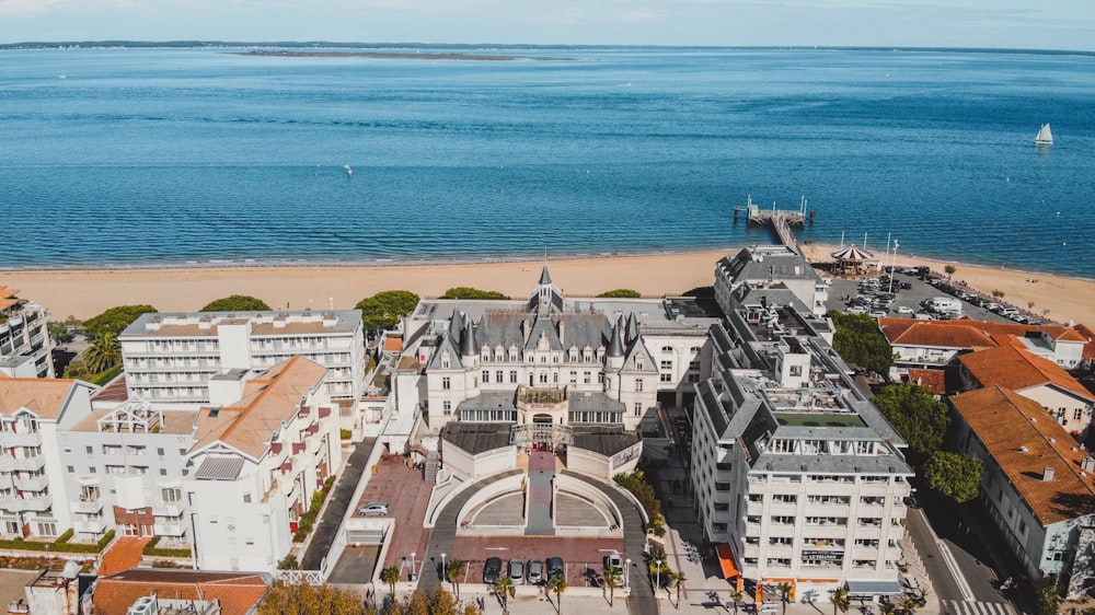 a bird's eye view of a large building next to the ocean