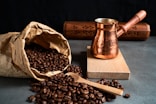 a bag of coffee beans next to a coffee grinder