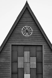 a black and white photo of a building with a clock