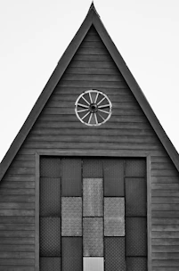 a black and white photo of a building with a clock