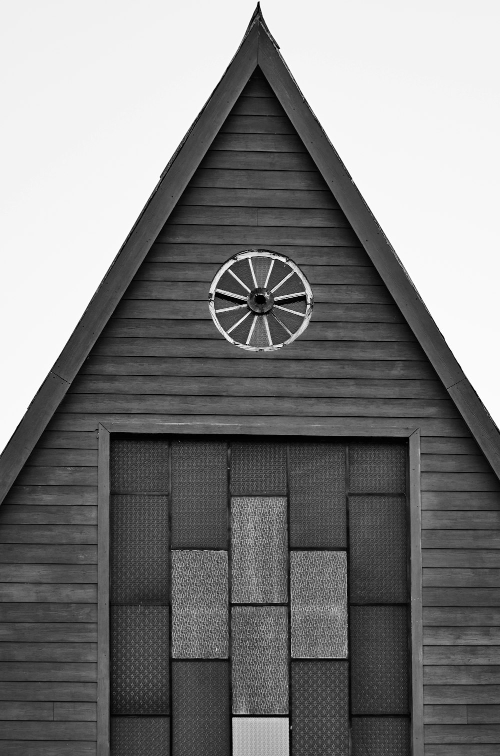 a black and white photo of a building with a clock