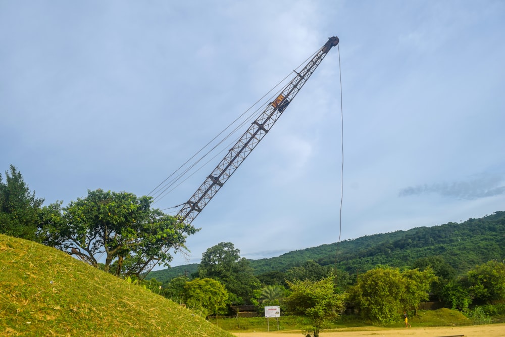 a crane is lifting a large mound of grass