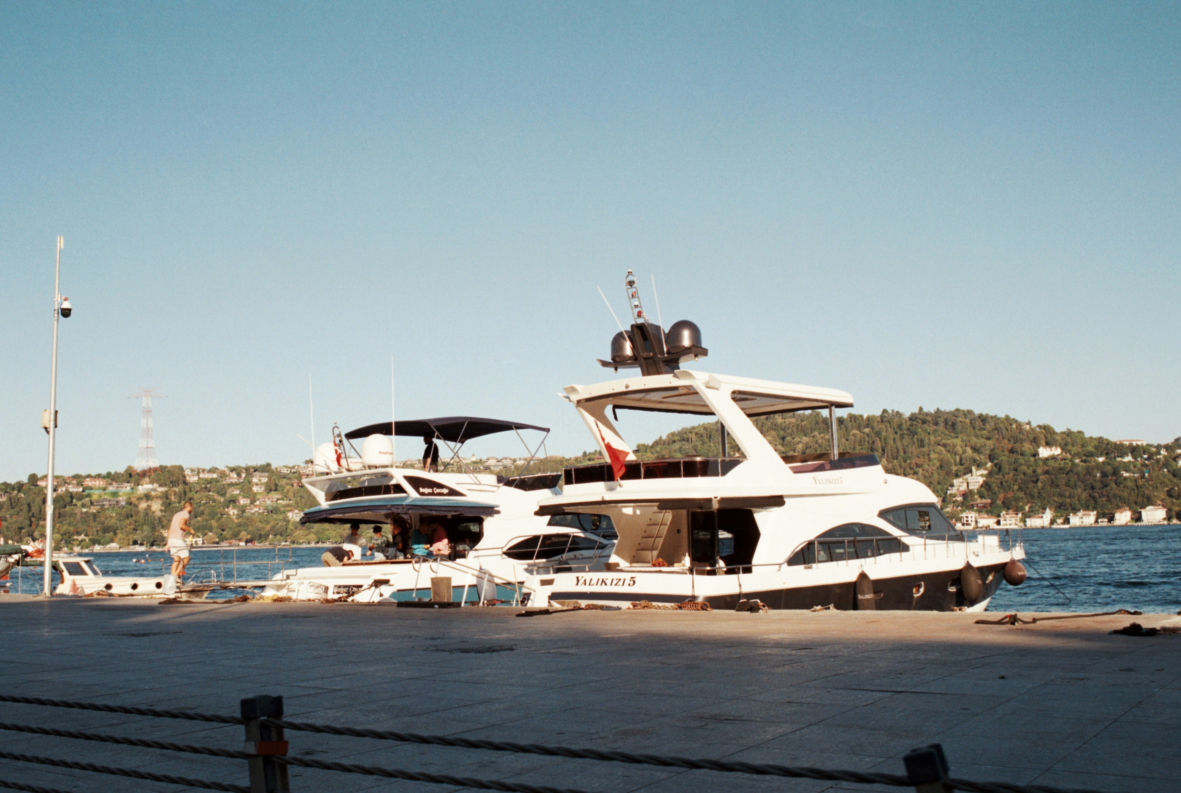 A tidy yacht galley set up for yacht provisioning with labelled storage tubs, a snack box, and a printed checklist