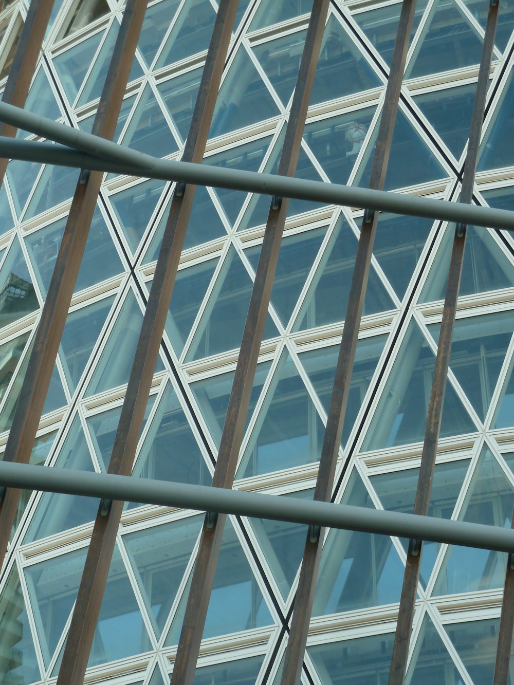 a large building with many windows reflecting the sky